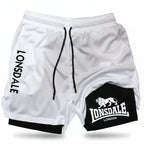 White athletic shorts with black drawstrings, featuring 'LONSDALE' printed vertically on one leg and a black patch on the other leg with the Lonsdale London lion logo.