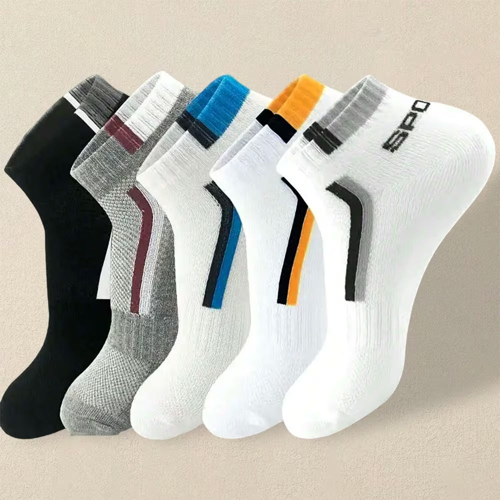 Set of six pairs of socks in black, gray, white, and multicolor on a beige background