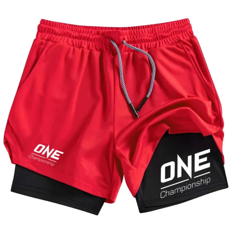 Red athletic shorts with a black inner layer visible at the hem, featuring white 'ONE Championship' logos on both legs and a gray-and-white drawstring, shown on a plain white background.