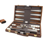 Backgammon set with pieces and dice in a wooden case on a white background
