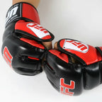 A pair of black and red UFC mixed martial arts gloves being worn on hands, shown against a plain white background.