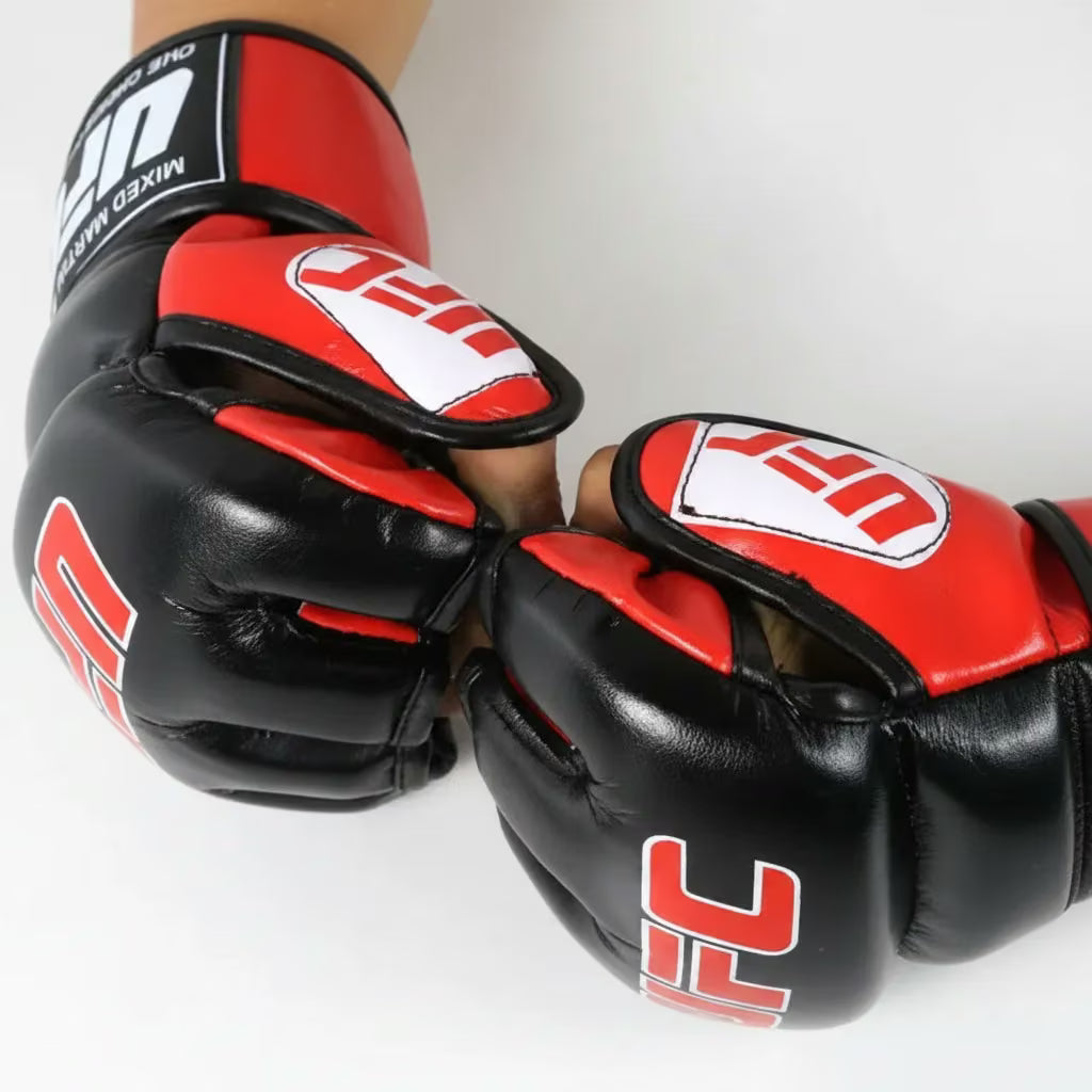 A pair of black and red UFC mixed martial arts gloves being worn on hands, shown against a plain white background.