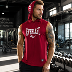 A man in a gym wearing a red sleeveless hooded tank top with 'Everlast' printed in white on the chest, paired with black shorts.