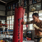 Red punching bag with a chain on a white background