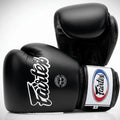 Black Fairtex boxing gloves on a light gray background