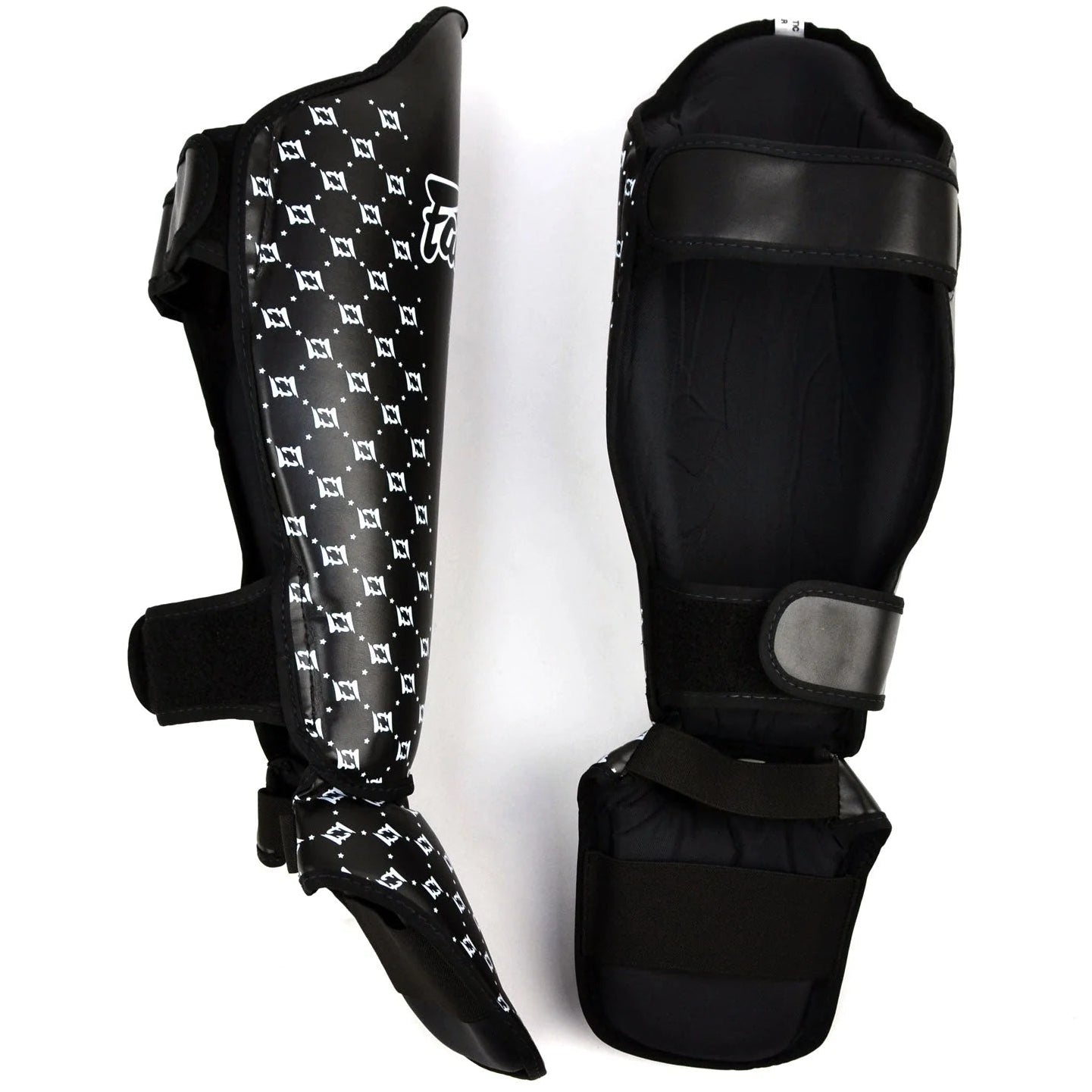 Black shin guards with patterned design on a white background