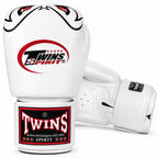A pair of white Twins Spirit boxing gloves on a clean white background, showing the front glove with the large red and black Twins Spirit logo and the front strap label, plus the back glove showing the wrist strap.