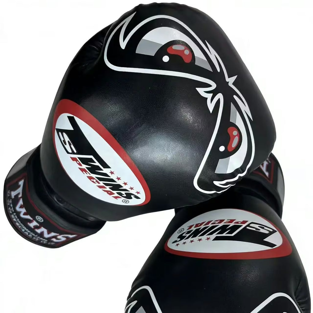 A pair of black boxing gloves with white and red graphics, including the brand name 'Twin Star' and a stylized eye logo, set against a plain white background.