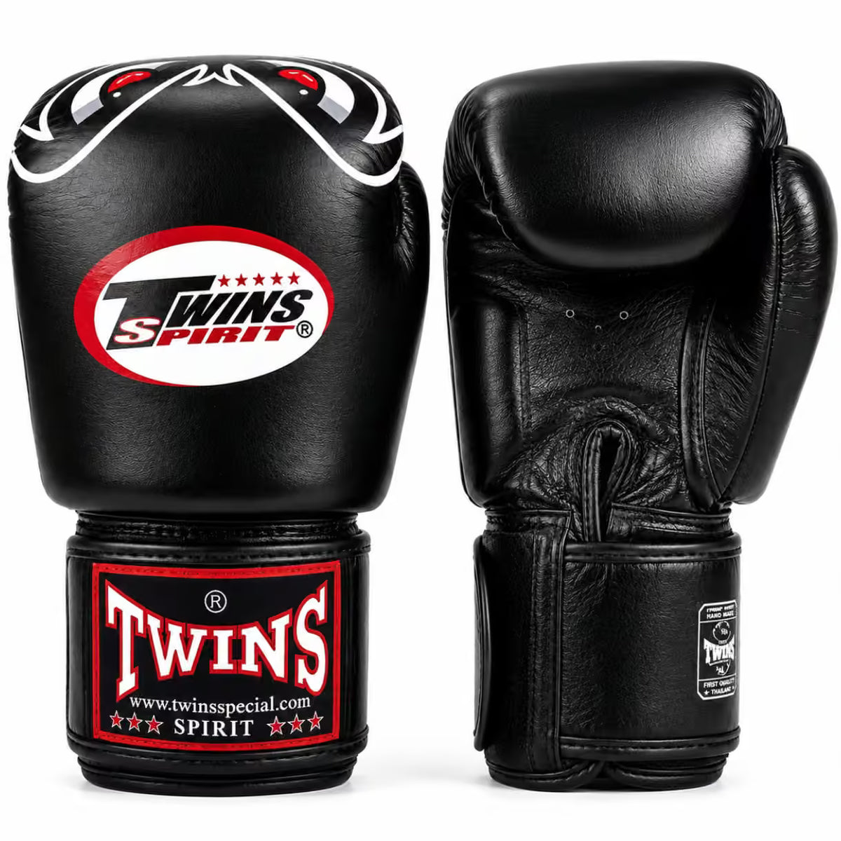 A pair of black leather boxing gloves shown from the front and back on a white background. The front glove features a red, white, and black 'Twins Spirit' logo patch on the knuckle and a matching red and white 'Twins' brand patch on the wrist strap.