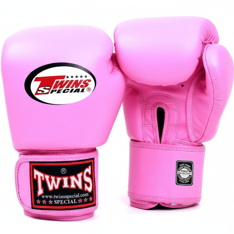 Pink boxing gloves with Twins Special logo on a white background