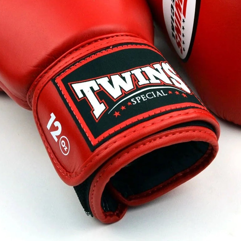 Red boxing gloves with Twins Special logo on a white background