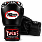 A pair of black Twins Spirit boxing gloves on a clean white background, showing the front glove with the main logo and the rear glove showing the wrist strap.