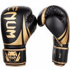 Black and gold boxing gloves with Venum branding on a white background