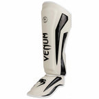 White shin guard with black accents and 'Venum' branding on a gray background
