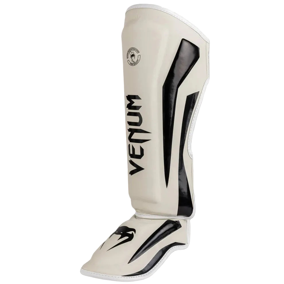 White shin guard with black accents and 'Venum' branding on a gray background
