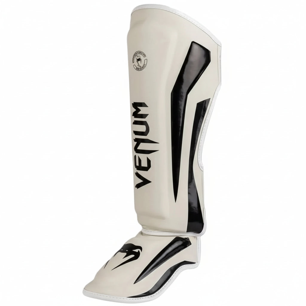 White shin guard with black accents and 'Venum' branding on a gray background