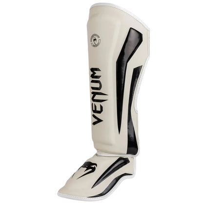 White shin guard with black accents and 'Venum' branding on a gray background